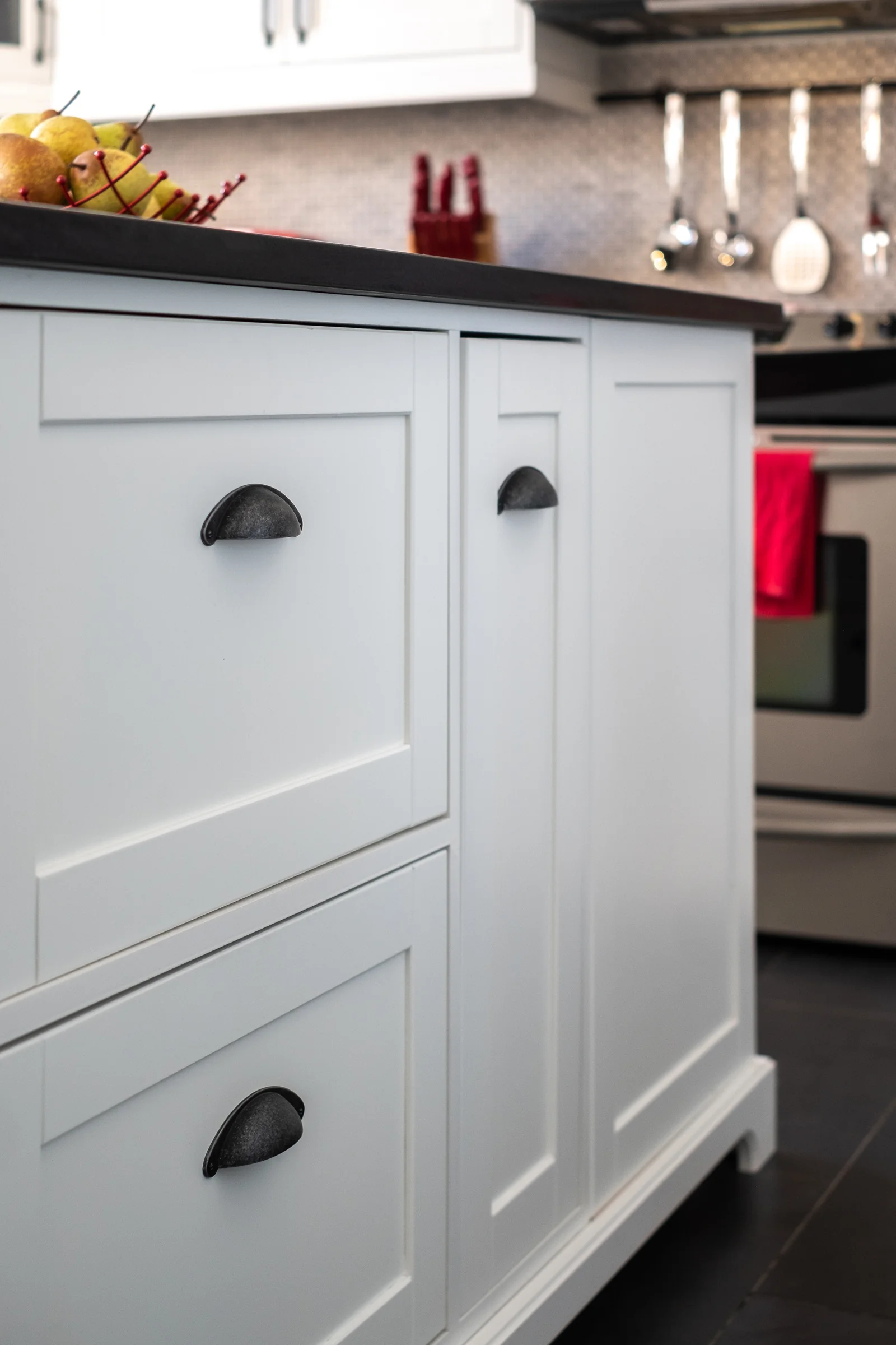 White kitchen island with industrial-style cup pulls