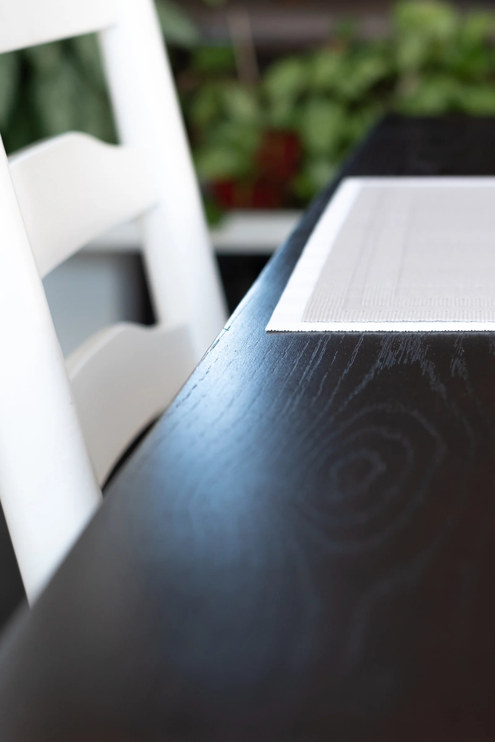 Dining table detail with dark wood and light accents