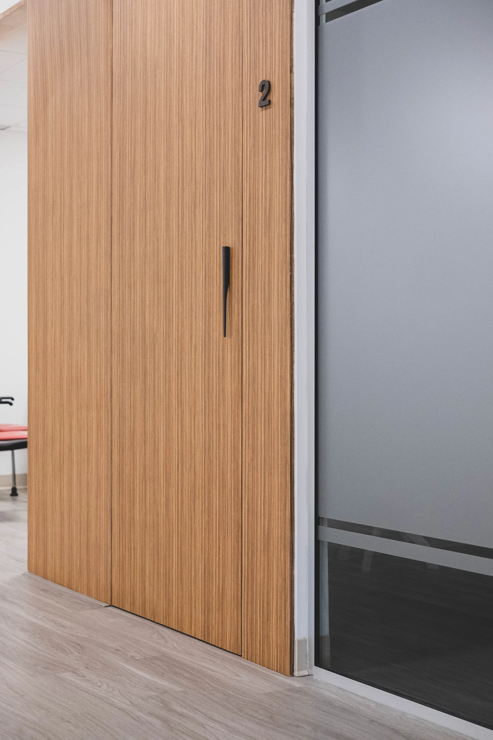 Tall wood-grained door with frosted glass partition