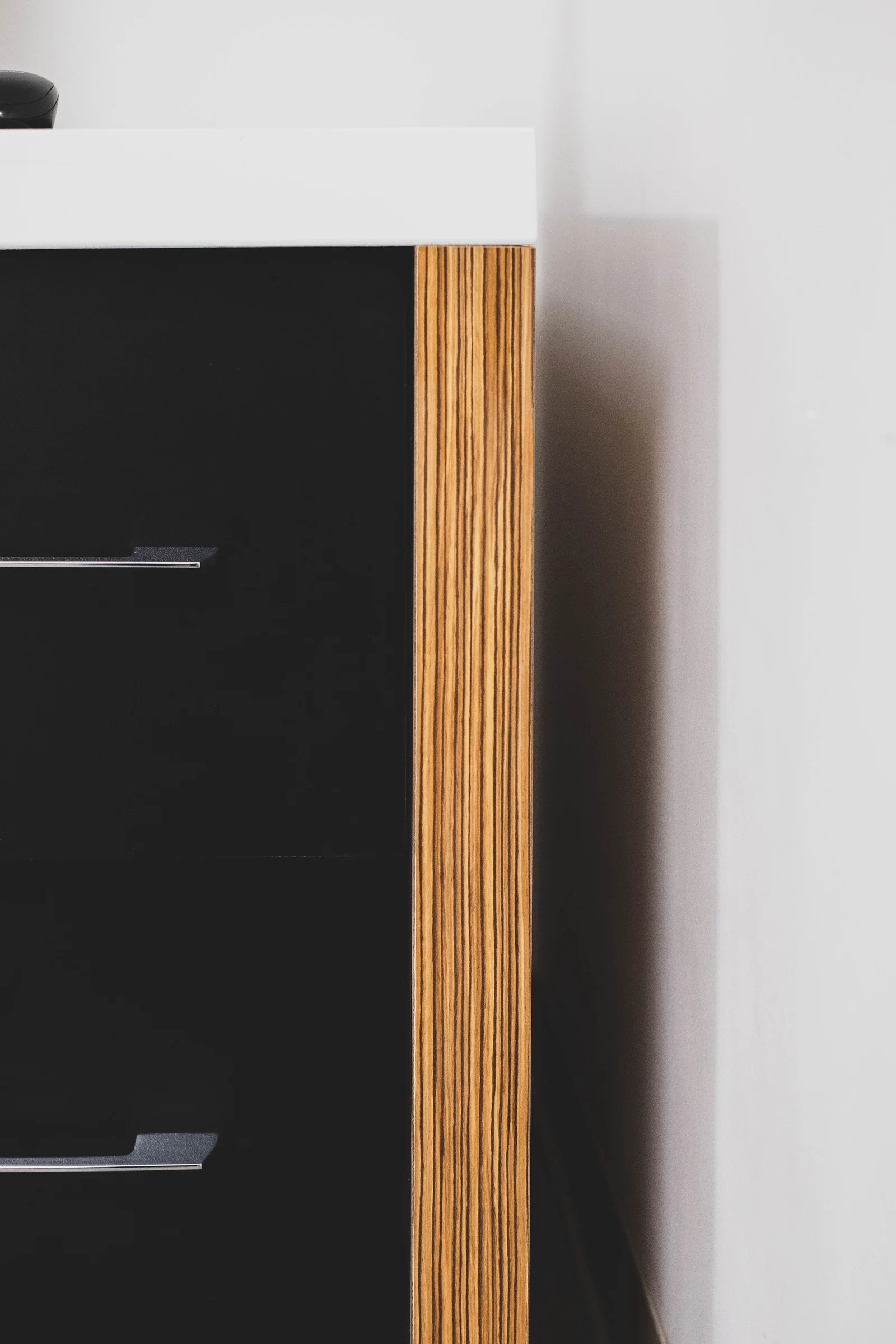 Desk with white, dark panels and wood grain accent
