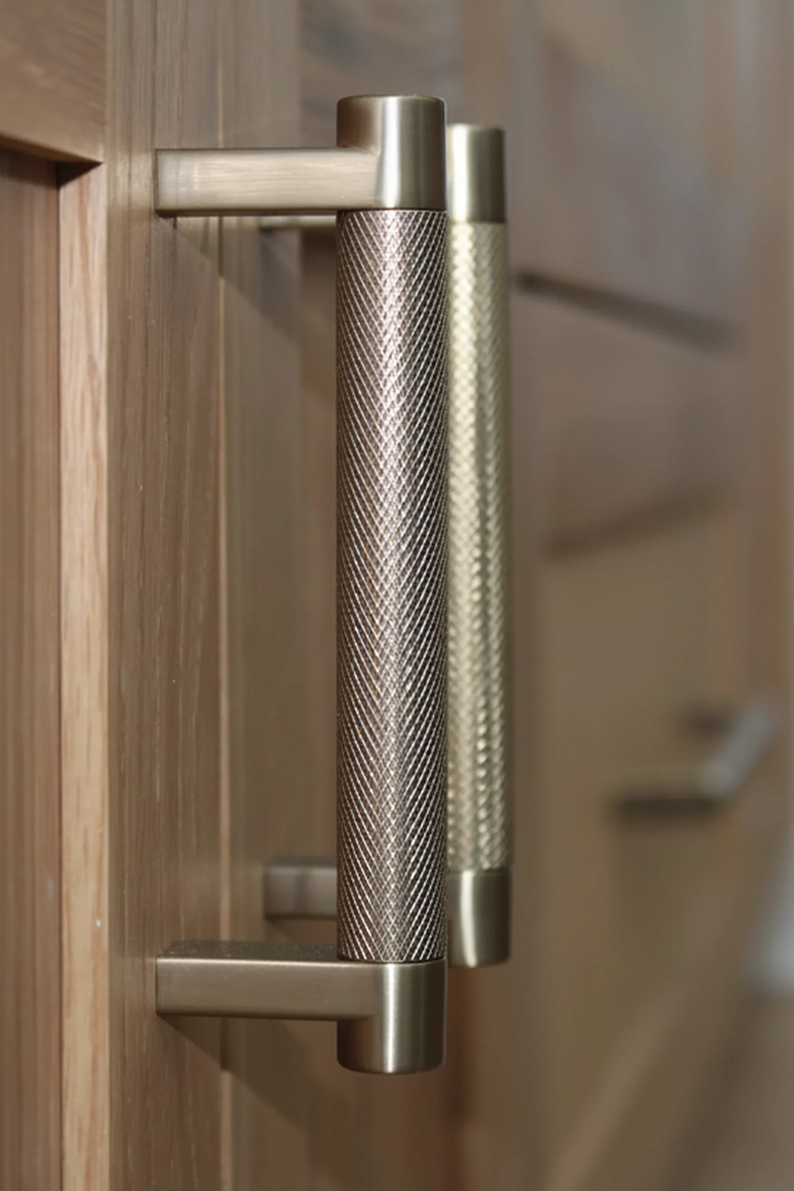 Metallic bar pulls on wood cabinetry